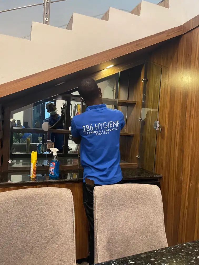 Professional cleaners smiling with cleaning tools